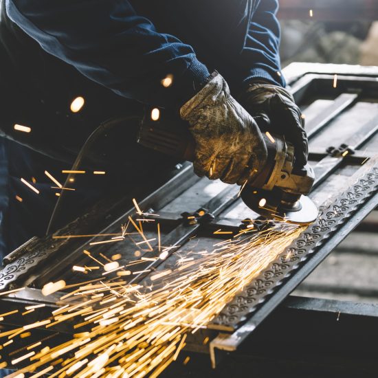 Man works with grinder machine.