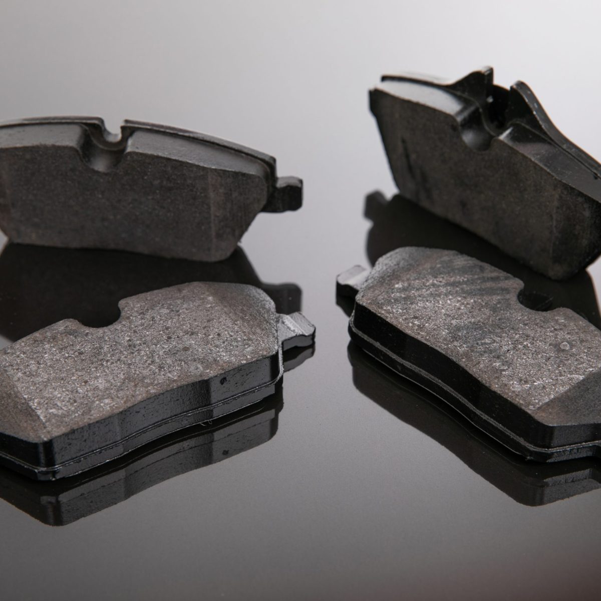 set of brake pads on a mirror background.
